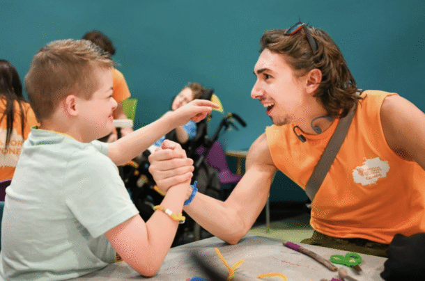 Brandon Gomes Toste arm wrestles Maverick during a session of the Creative Discovery Museum’s Friends’ Discovery Camps. 